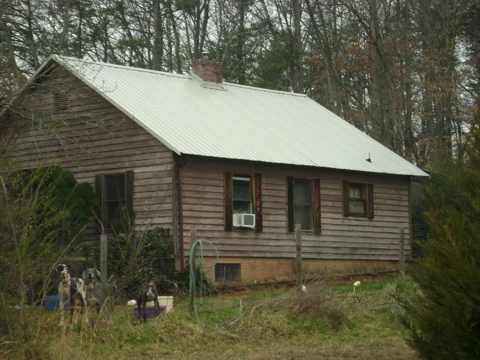 White metal roof on an old wood sided farmhouse, from a Metal Roof Installation job in Huntingtown